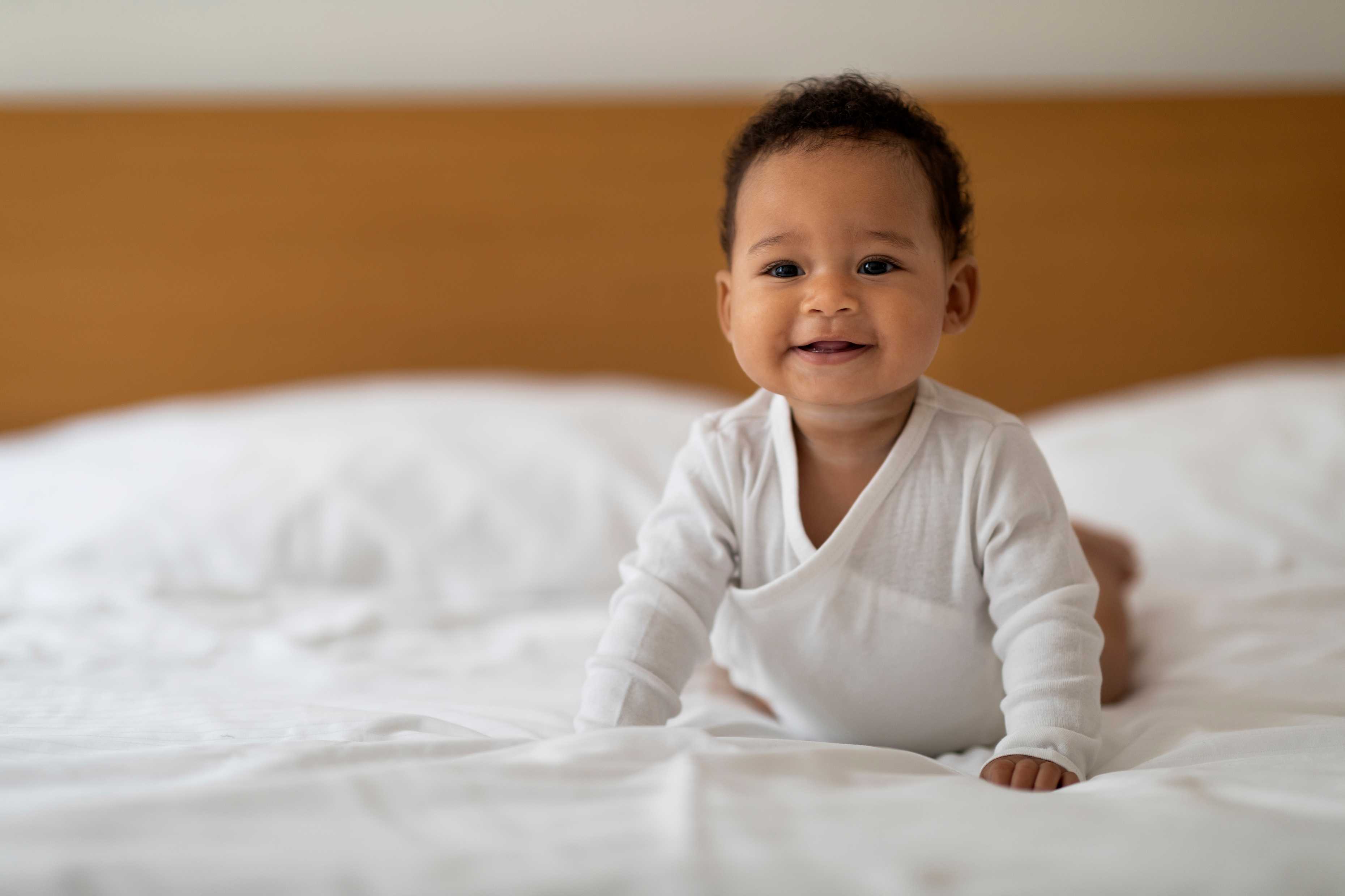 Smiling baby on a bed